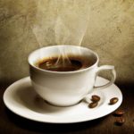 steaming-cup-of-coffee-with-coffee-beans-spilled-copy